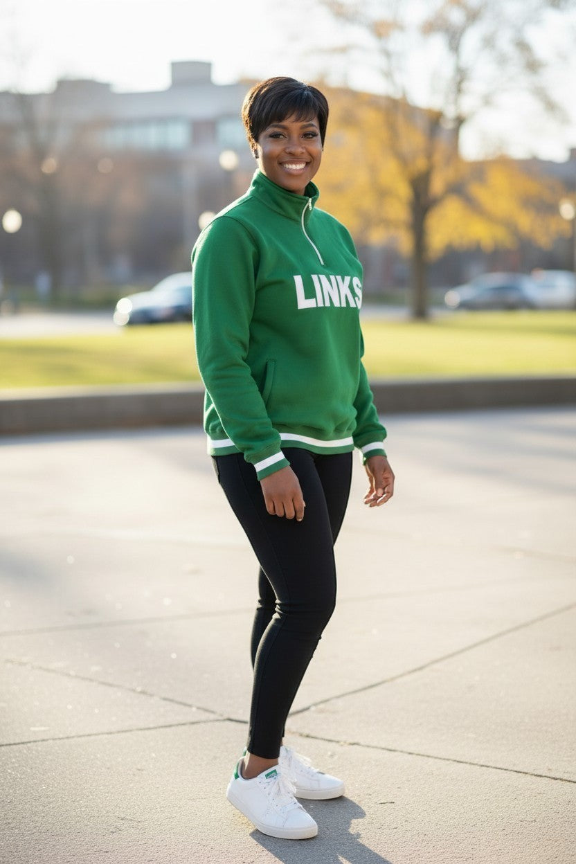 Ooh Soo Crafty LLC green quarter zip pullover sweatshirt with white "LINKS" graphic, white striped cuffs and hem, worn by a woman.
